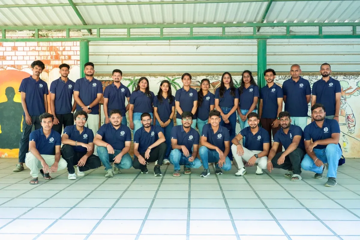 The Brand Elite team in matching navy polo shirts, standing and crouching in two rows